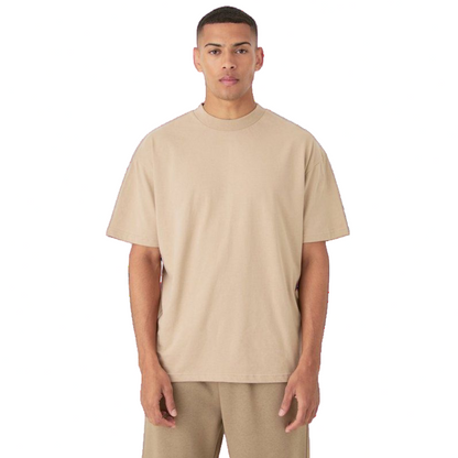 Man wearing a beige t-shirt and pants on a white background